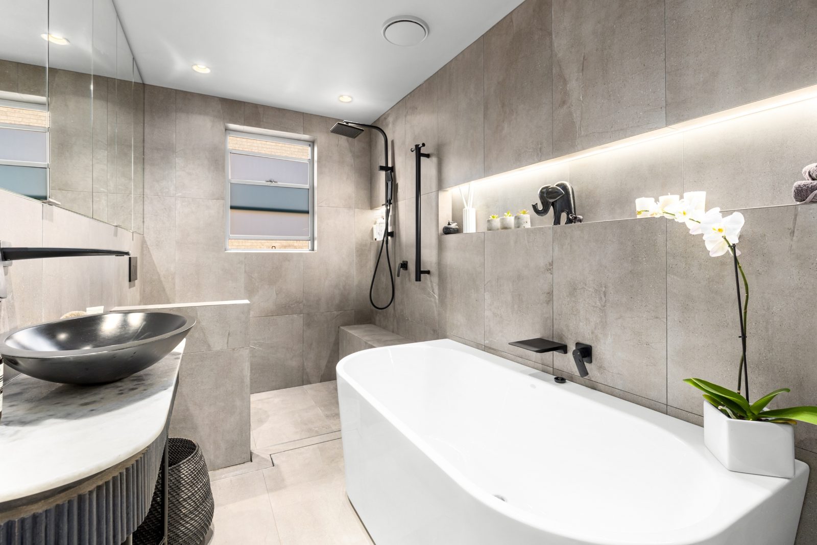Bathroom with freestanding bath and stone vanity