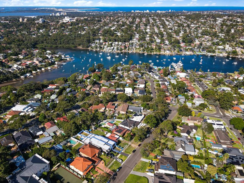 Aerial view of a suburb on a bay with moored boats