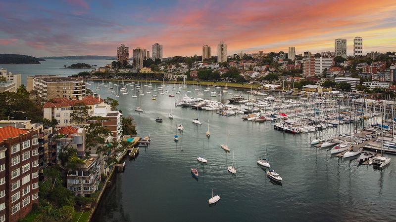 Harbourside apartments and a marina at sunset