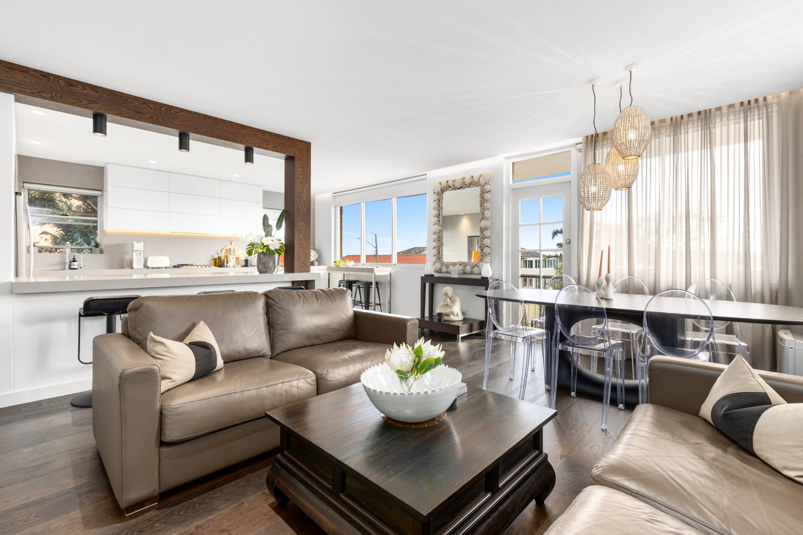 Bright open plan living and kitchen with leather sofas