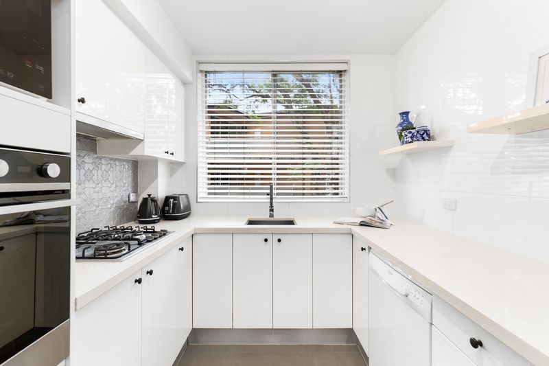 White kitchen with a gas cooktop