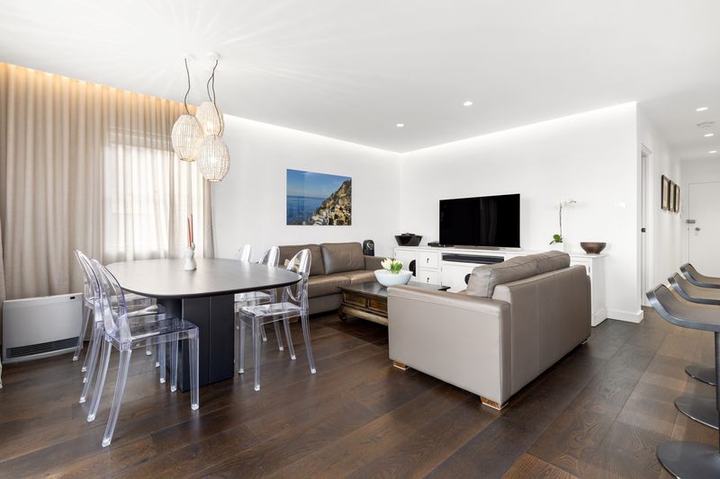 Dining table and lounge under pendant lights