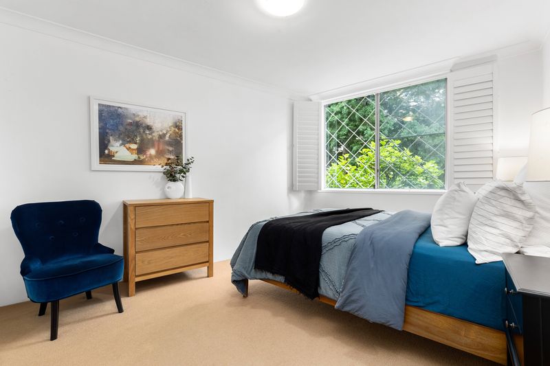 Bedroom with a blue velvet armchair
