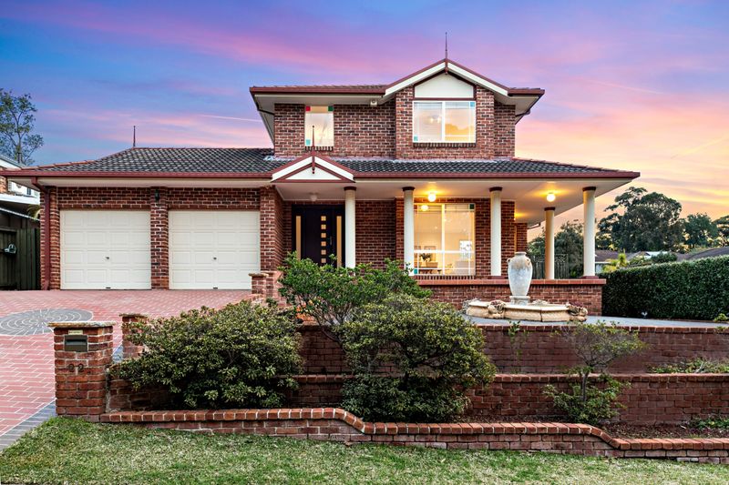 Front of a two storey brick home at dusk