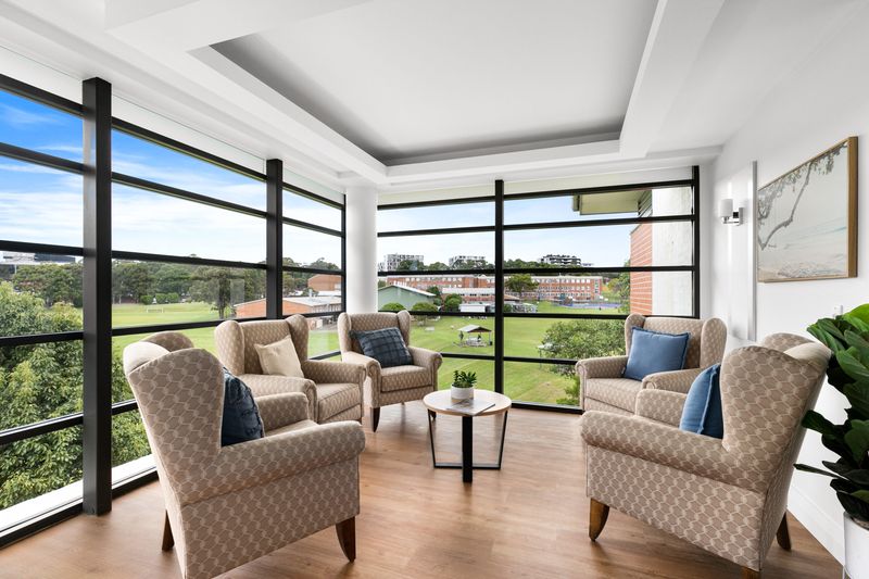 Lounge with tall windows over a park